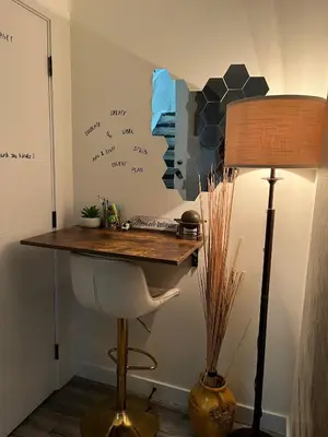 a desk and a lamp in a room with writing on the wall at Cozy Haven! in Edmonton