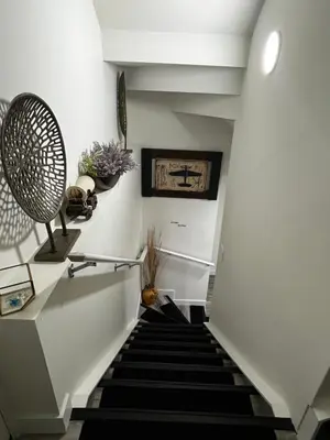 a stairway with a black and white staircase at Cozy Haven! in Edmonton