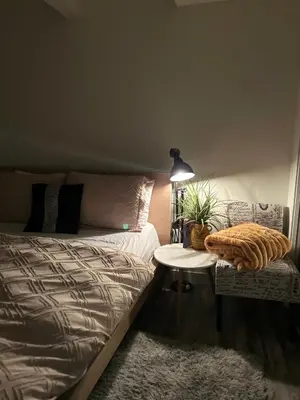 a bedroom with a bed and a table and a chair at Cozy Haven! in Edmonton