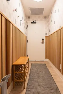 a hallway with a door and a table and a rug at Tally Ho by Revelstoke Vacations in Revelstoke