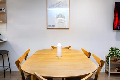 a wooden table with chairs and a candle on it at Separate Reality Retreat by Revelstoke Vacations in Revelstoke