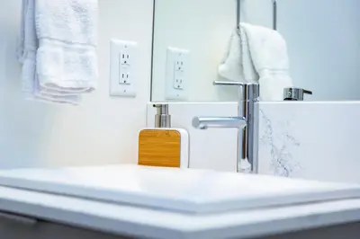a bathroom sink with a soap dispenser on it at Separate Reality Retreat by Revelstoke Vacations in Revelstoke