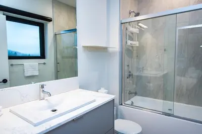 a bathroom with a sink and a shower and a toilet at Tumbledown Condo by Revelstoke Vacations in Revelstoke