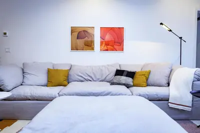a living room with a blue couch with yellow pillows at Tumbledown Condo by Revelstoke Vacations in Revelstoke
