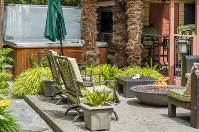 a patio with chairs and an umbrella and a fountain at Luxury Retreat in Vancouver in Vancouver