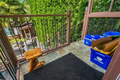 a balcony with a gate with a bench and trash at Luxury Retreat in Vancouver in Vancouver
