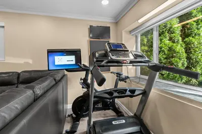 a home gym with a treadmill and a computer at Luxury Retreat in Vancouver in Vancouver