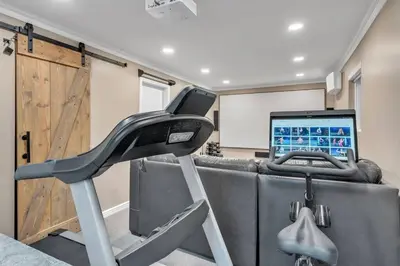 a gym with a treadmill in a room with a laptop at Luxury Retreat in Vancouver in Vancouver