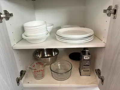a cupboard filled with plates and bowls and dishes at B211 MTN View ground floor town house- 2BD, Sleeps 8, hot tub, free parking, close to Banff in Canmore