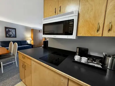 a kitchen with a microwave and a counter top at Eldorado, a Coast Hotel in Dawson City