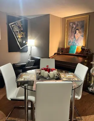 a dining room with a glass table and white chairs at West Edmonton Perle Palace in Edmonton