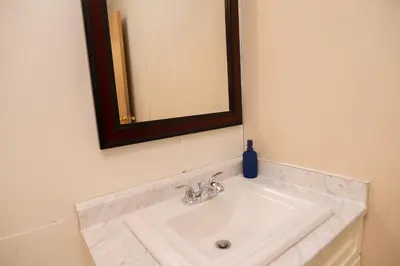 a bathroom with a sink and a mirror at 3 Bedroom Gardenside Downtown Home in Whitehorse