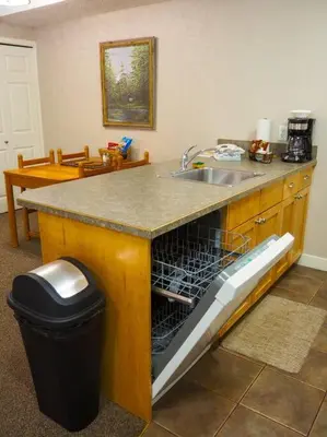 an open dishwasher in a kitchen with a sink at Cozy apartment in the heart of Panorama in Panorama