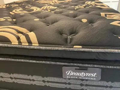 a mattress sitting on top of a black blanket at Luxury unit in the heart of Canmore in Canmore