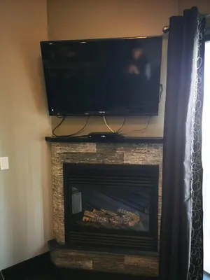 a fireplace with a flat screen tv and a fire place at Sweet Condo Canmore GR\uff1a\uff09 in Canmore