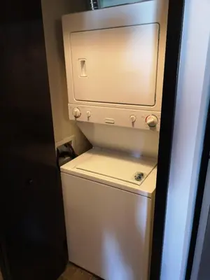 a small white refrigerator in a small room at Sweet Condo Canmore GR\uff1a\uff09 in Canmore