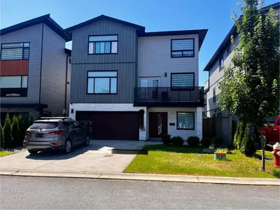 a car parked in front of a house at New, Spacious 2 Bedrooms in Downtown With Free Parking! in Maple Ridge District Municipality