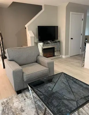 a living room with a couch and a television at New Townhouse in Red Deer in Red Deer