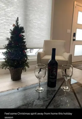 a bottle of wine and two wine glasses on a table at New Townhouse in Red Deer in Red Deer
