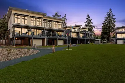 a large building with a lawn in front of it at Ocean View Townhouse #26 at THE BEACH HOUSE in Campbell River