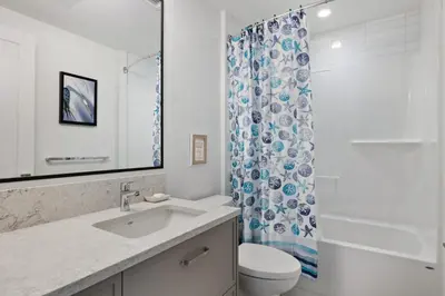 a bathroom with a sink and a toilet and a shower at Ocean View Townhouse #26 at THE BEACH HOUSE in Campbell River