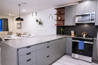 a kitchen with white cabinets and a counter top at Revelstoke Marvel - Two Bedroom with Hot Tub in Revelstoke