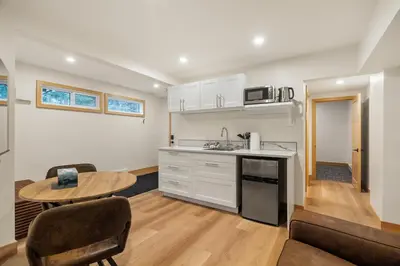 a kitchen and living room with a table and chairs at Elkhorn Lodge Vacation Rentals in Banff