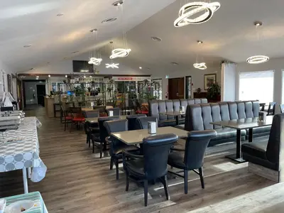 a restaurant with tables and chairs and a bar at The 22 Hotel in Cremona