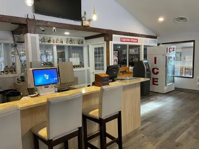 a store with a bar with two chairs at a counter at The 22 Hotel in Cremona