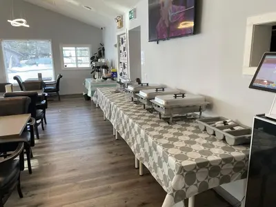a row of tables and chairs in a restaurant at The 22 Hotel in Cremona
