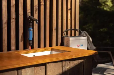 a wooden table with a hammer on a fence at Stay Wilder Sunshine Coast in Sechelt