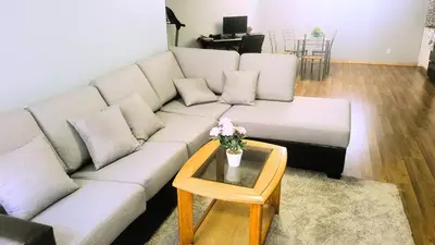 a living room with a white couch and a table at Cozy 2-Bedroom Basement Suite Retreat Calgary in Calgary