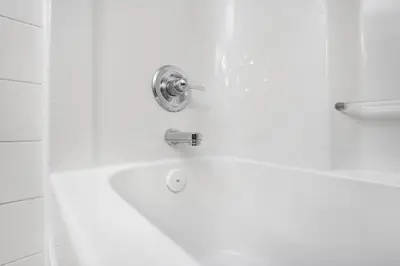 a bath tub with a faucet in a bathroom at Cozy 2-Bedroom Basement Suite Retreat Calgary in Calgary