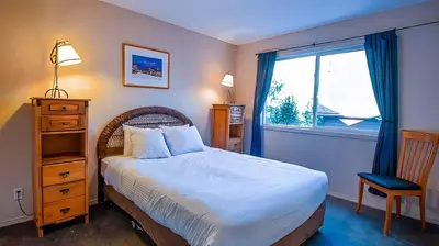 a bedroom with a large bed and a window at Polar Peak Chalet by Fernie Lodging Company in Fernie
