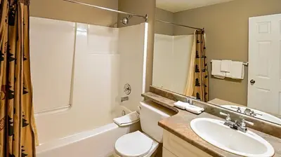 a bathroom with a sink and a toilet and a shower at Polar Peak Chalet by Fernie Lodging Company in Fernie