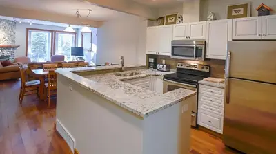 a kitchen with white cabinets and a large counter top at Polar Peak Chalet by Fernie Lodging Company in Fernie