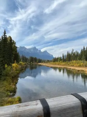 a view of a river with mountains in the background at Mountain Escape sleeps 10 Guests in this 3BD 2BT Top Floor Condo with Mountain View in Canmore