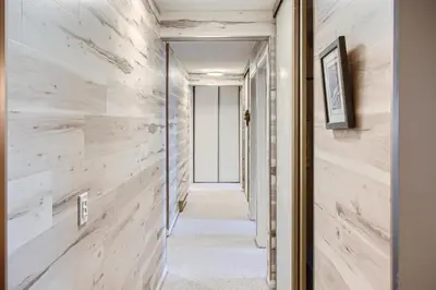 a hallway with wood paneled walls and a doorway at Ponderosa Inn by Okanagan Premier in Big White