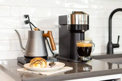 a coffee maker and a plate of food and a cup of coffee at Coastal Creative Garden Studio in Colwood