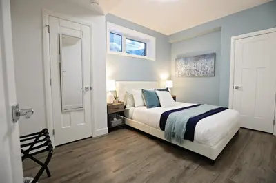 a bedroom with a large bed and a window at Queen Suite 20 Min from YEG Airport with Disney in Edmonton