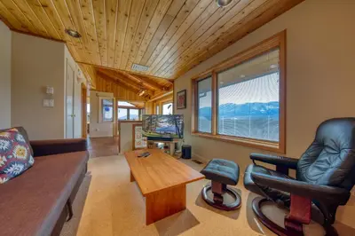 a living room with a couch and a table at CLIFF CABIN Family Friendly|Hot Tub|Spectacular Views in Fairmont Hot Springs