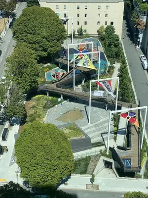 an overhead view of a park with trees and a building at Richard Comfort Living in Vancouver