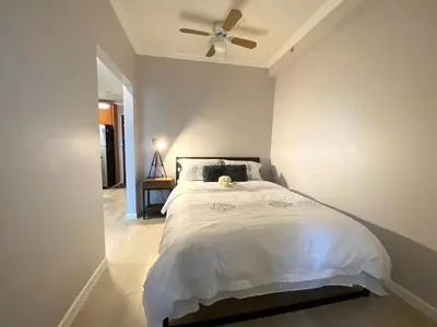 a bedroom with a bed with a ceiling fan at Richard Comfort Living in Vancouver