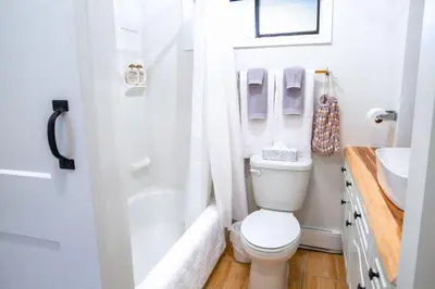 a bathroom with a toilet and a shower and a sink at The Nook, Top Floor Suite with Lake and Mtn View in Harrison Hot Springs