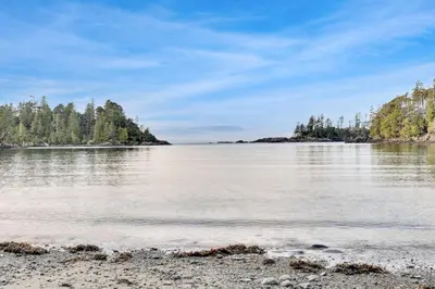a view of a lake with trees in the distance at Grey Whale, Pet Friendly Studio at The Beach in Ucluelet