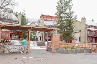 a pavilion with a fountain in front of a building at Moguls, Lofted Ski in Ski Out with Hot Tub Access in Panorama