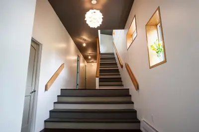 a staircase in a house with a chandelier at Boreale Ranch in Carcross