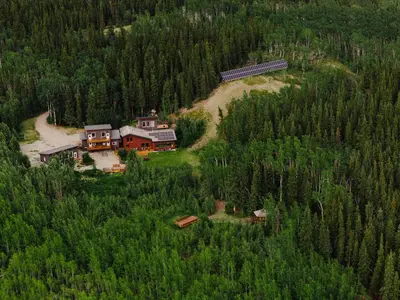 an aerial view of a house in the middle of a forest at Boreale Ranch in Carcross