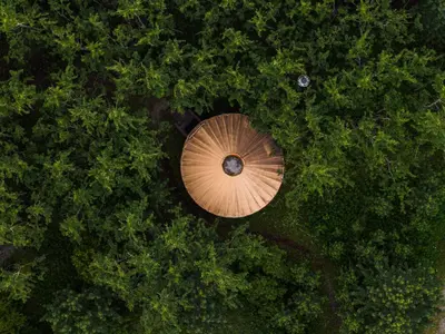 an overhead view of a wooden umbrella in a forest at Boreale Ranch in Carcross