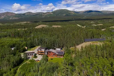 an aerial view of a house in the mountains at Boreale Ranch in Carcross